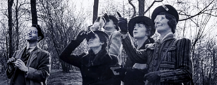 Video still from "Christmas Bird Count" told by Chan Robbins - an old image of a man and several women birdwatching with binoculars. 